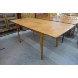 A teak extending dining table