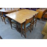 A teak extending dining table and four chairs