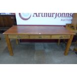 A large early 20th Century oak and beech three drawer library table