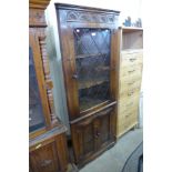 A Bevan Funnel carved oak freestanding corner cabinet