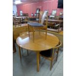 A teak extending dining table and three chairs