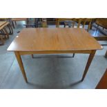 A teak extending dining table