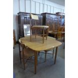 A G-Plan teak extending dining table and four G-Plan Fresco dining chairs