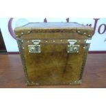 A brown leather and brass mounted trunk