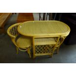 A bamboo and glass topped table and two chairs