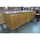 An Ensign teak and elm sideboard designed by Bristow and Townsend