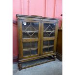 An early 20th Century carved oak two door bookcase