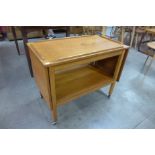 A teak metamorphic trolley/nest of tables