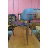 An Elliots of Newbury teak and black vinyl elbow chair