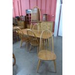 An Ercol Blonde elm and beech plank top dining table and six Quaker chairs