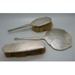 A three piece silver Art Deco hand mirror and brush set, Birmingham 1930/31