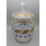 A glass biscuit barrel with enamel design