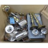 A box of mixed metalwares including a pair of brass candlesticks, part canteen of cutlery, stainless