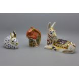 Three Royal Crown Derby paperweights, Laying Foal and Squirrel both with silver stoppers and Bunny