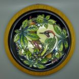 A framed Moorcroft charger, Bird, 26cm