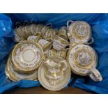 An Edwardian porcelain tea set, sixteen cups, eleven saucers, tea pot, lidded sugar pot, cream