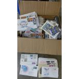 A box of approximately 200 first day covers and loose stamps