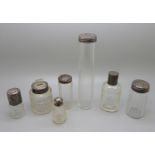 A collection of seven silver topped bottles, scent and salts jar, including Victorian