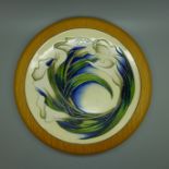 A framed Moorcroft charger, Lilies, 2005, trial version, 22cm