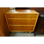 A teak chest of drawers