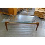 A teak and glass topped rectangular coffee table