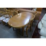 A Nathan teak extending dining table and four chairs