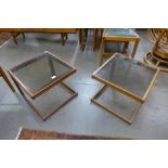 A pair of teak and glass topped occasional tables