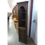 A 17th Century style carved Ipswich oak corner cabinet