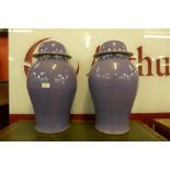 A pair of oriental purple porcelain ginger jars and covers