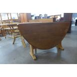 An Ercol Blonde elm and beech drop leaf table