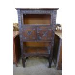 An early 20th Century carved oak side cabinet