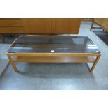 A teak and glass topped rectangular coffee table