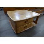 An Ercol Blonde elm Pandora's box coffee table