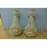 A pair of French Empire style gilt metal and glass bag shaped chandeliers