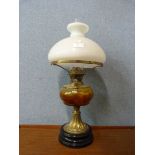 A Victorian brass and smoked glass oil lamp