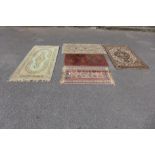 Five assorted small eastern rugs