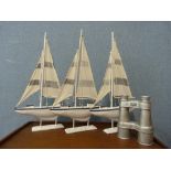 Three decorative sailing ships and a set of silver coloured binoculars