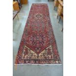 A Persian red ground Herris runner rug, 427 x 115cms