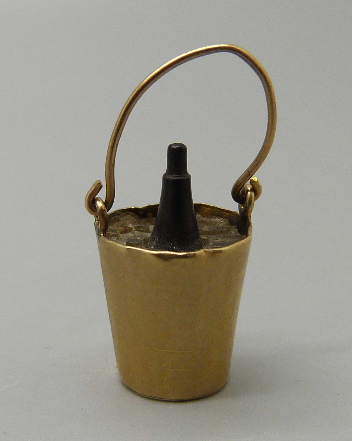 A 9ct gold champagne bucket and bottle charm, 1.6g