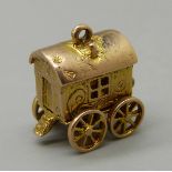 A 9ct gold Romany fortune teller's caravan charm, bottom opens to reveal fortune teller with a