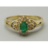 A yellow metal, emerald and diamond ring, marked 18K, 3.2g, O