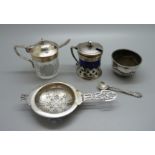 A silver strainer and salt, 70g, a silver mounted mustard, a plate and blue glass mustard and a a