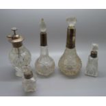 A collection of five silver mounted glass scent bottles, one stopper chipped
