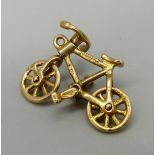 A 9ct gold bicycle charm, with moving wheels, handlebars and pedals, 2.1g