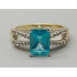 A silver gilt, neon apatite ring with zircon shoulders, N