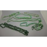 A collection of green glass beads