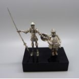 A model of Don Quixote and Sancho Panza, silver covered figures, base 9cm wide