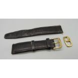 A gentleman's Omega watch buckle on a leather strap and a lady's Omega watch buckle