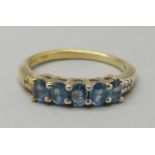 A silver gilt and blue stone ring, O