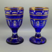 A pair of Bohemia blue glass goblets with gilt decoration, 17.5cm